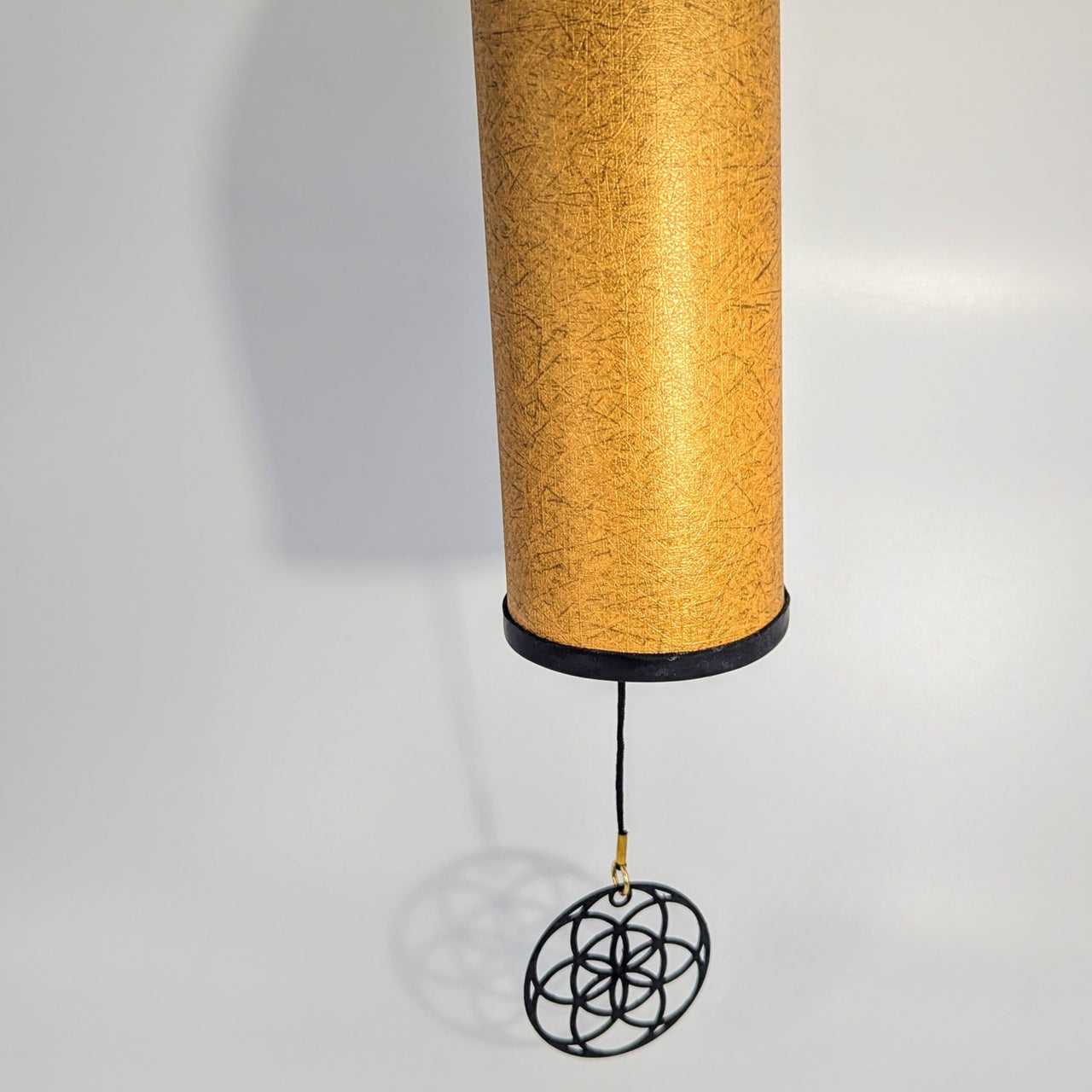 Authentic Koshi Aria wind chime with golden texture and black flower base