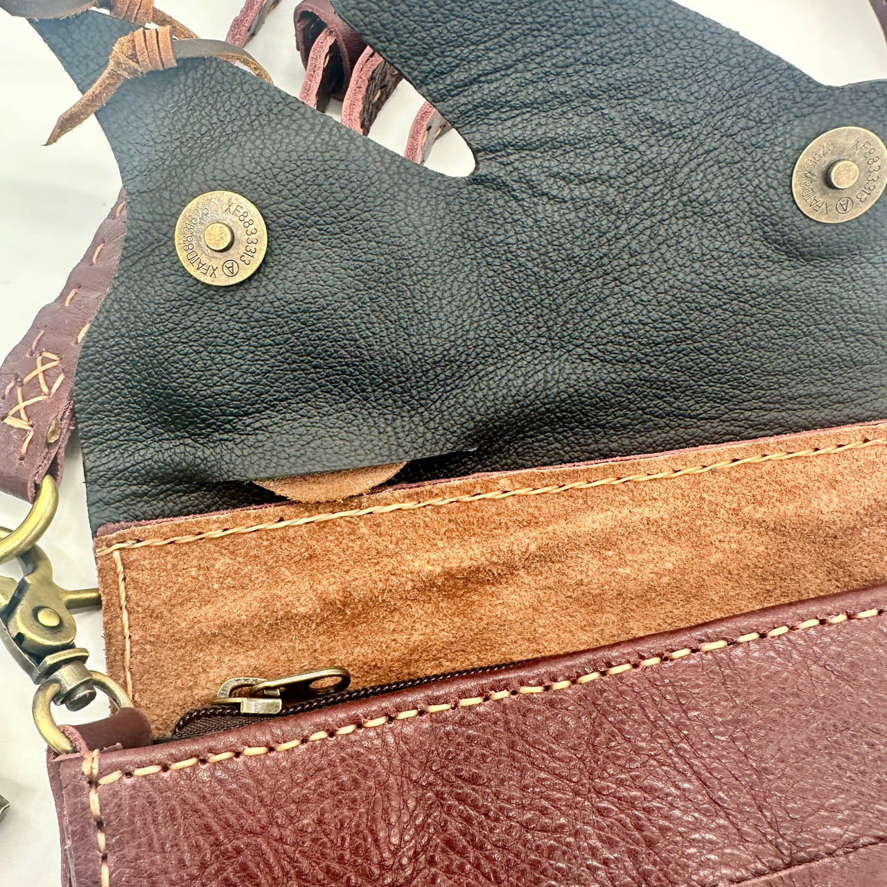 Authentic handmade leather crossbody bag with tan suede lining and brass accents