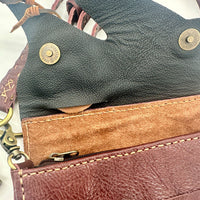 Authentic handmade leather crossbody bag with tan suede lining and brass accents