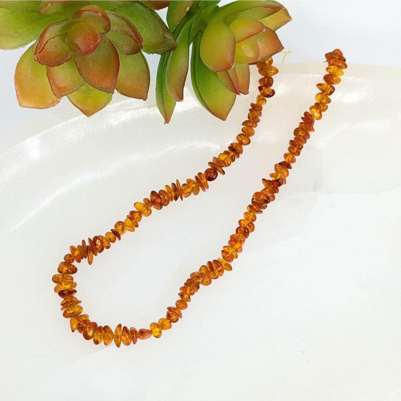 Amber 3mm chip beads strand featuring irregular-shaped Baltic Amber stones