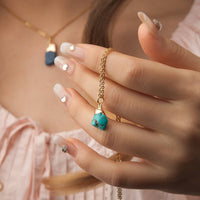 Turquoise birthstone pendant on adjustable 16-18 inch brass chain, natural veining