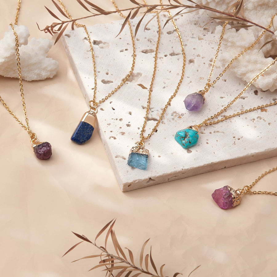 Birthstone necklaces with raw gemstone pendants on adjustable brass chains