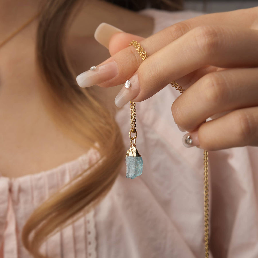 Delicate gold chain necklace with raw light blue birthstone pendant on 16-18 inch adjustable brass chain BC0400