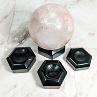 Thumbnail for Pink quartz sphere with black hexagons on marble table in Black Obsidian Sphere Holder