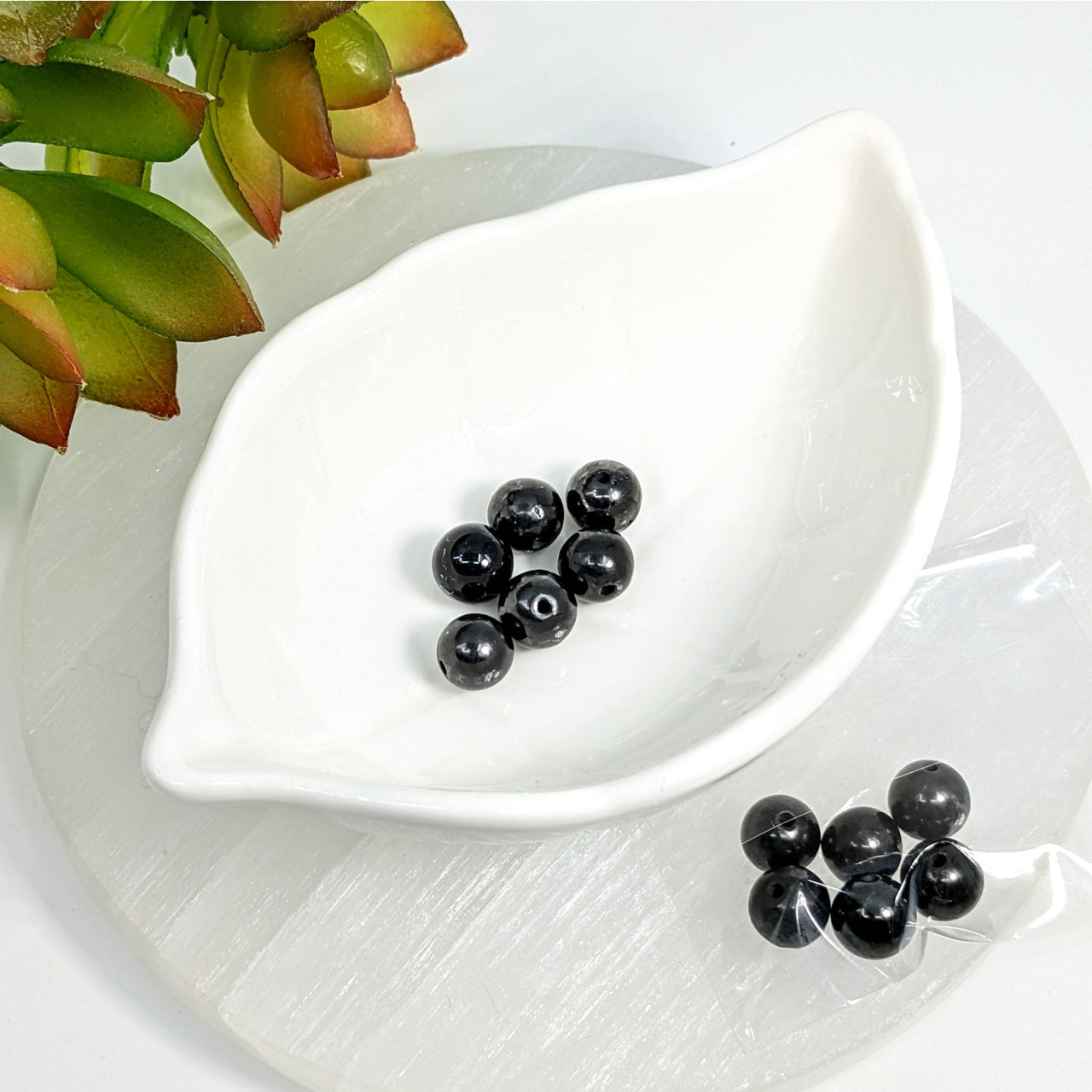 White leaf-shaped ceramic dish with Black Shungite 5mm round beads display