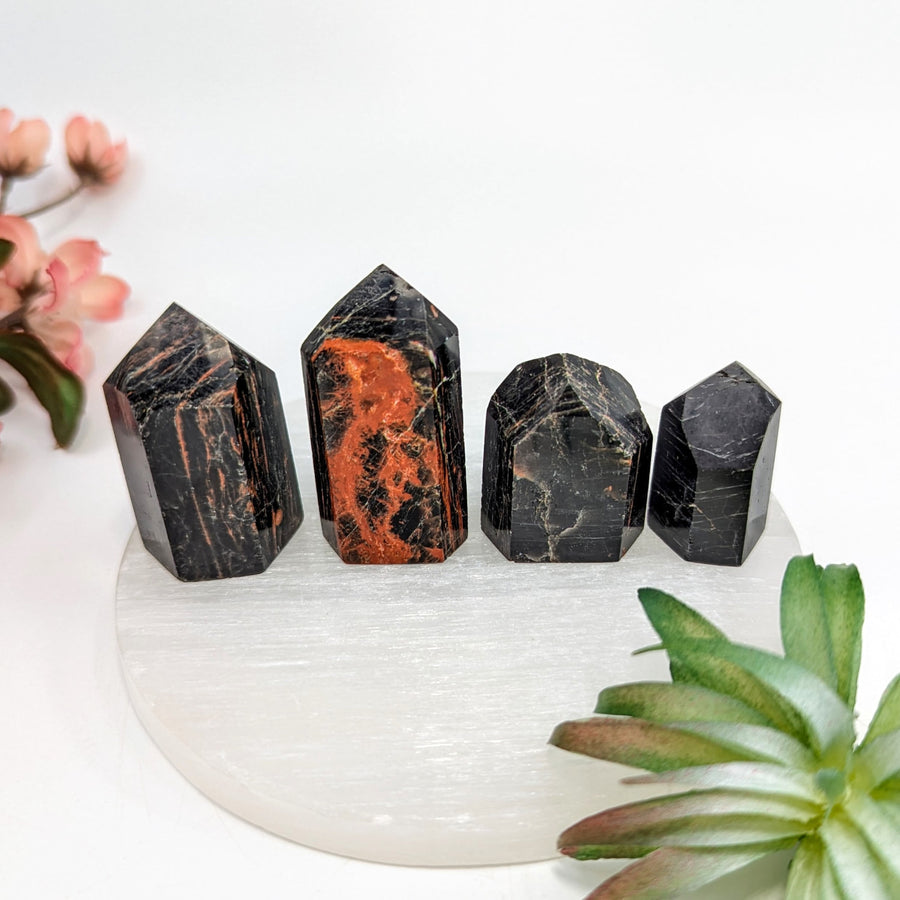 Black Tourmaline crystals with four black crystal towers on a white background