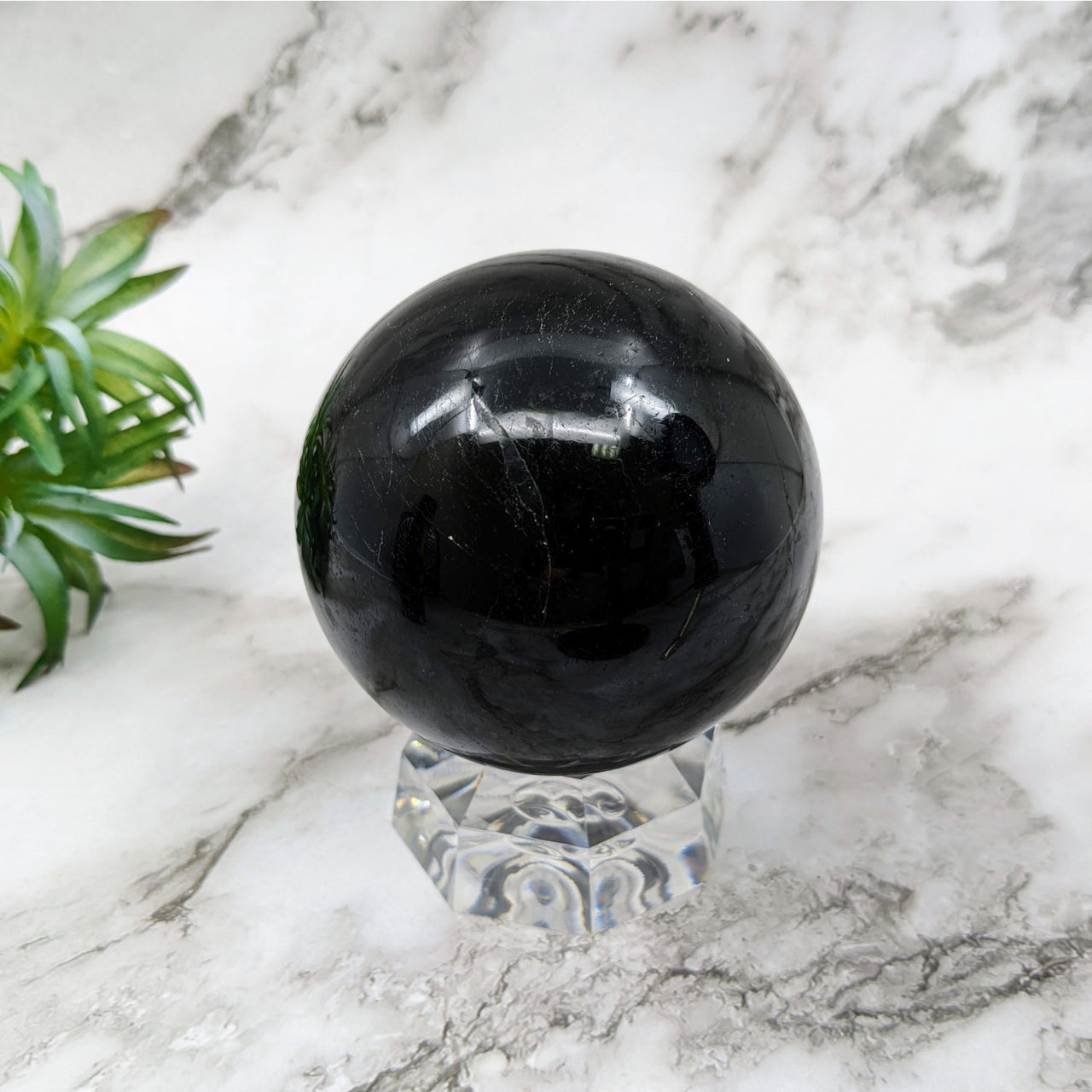 Black Tourmaline 2.9’ Sphere #LV5246 on a marble table
