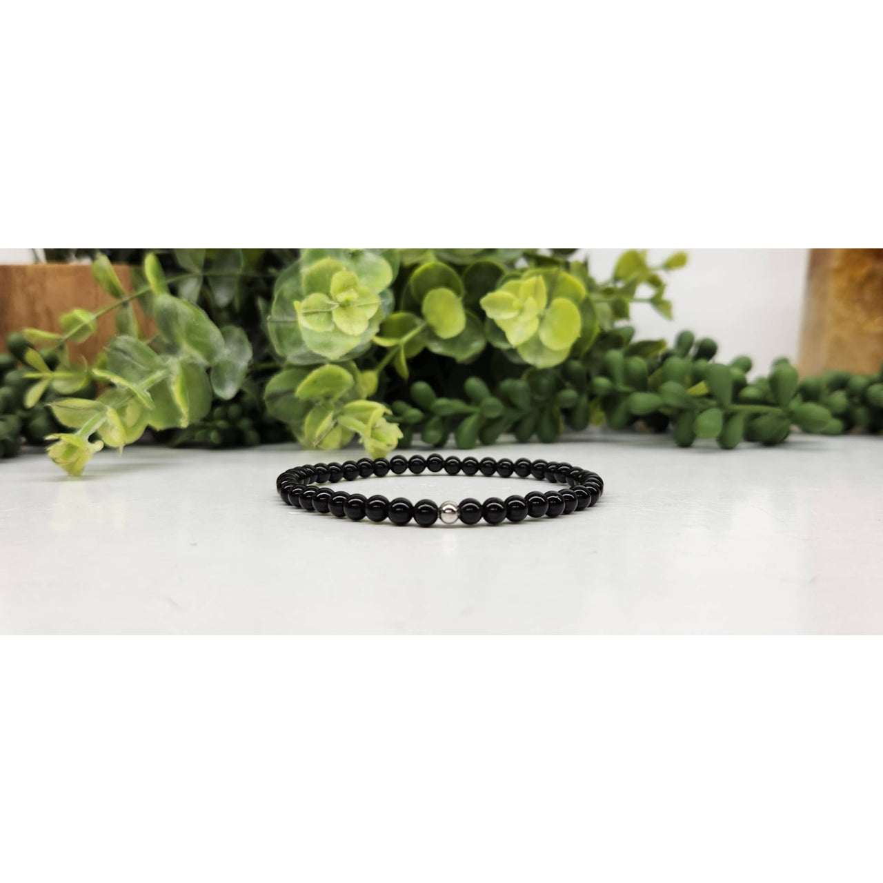 Black Tourmaline bracelet featuring 4mm uniform spherical black beads, 7 inches long