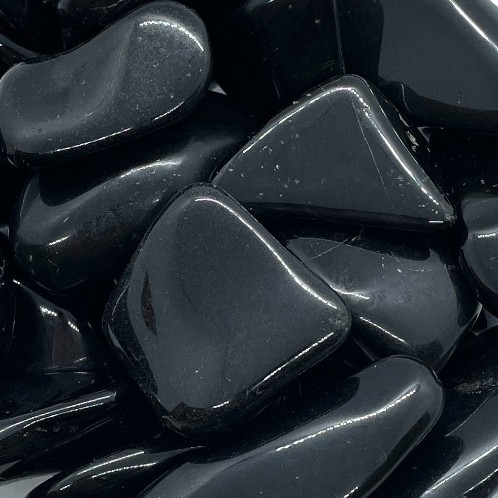 Polished black obsidian stones in Black Tourmaline Tumbled #T018 with glossy surfaces