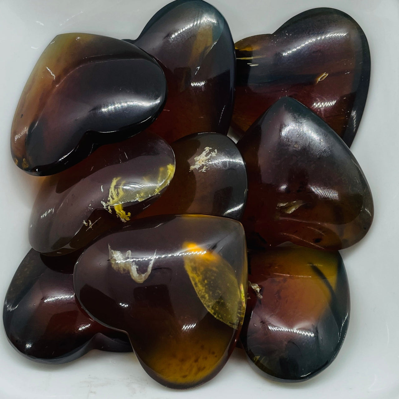 Amber-colored heart-shaped stones with captivating blue hue and ancient energy in Blue Amber 1.5’’ Heart #H054