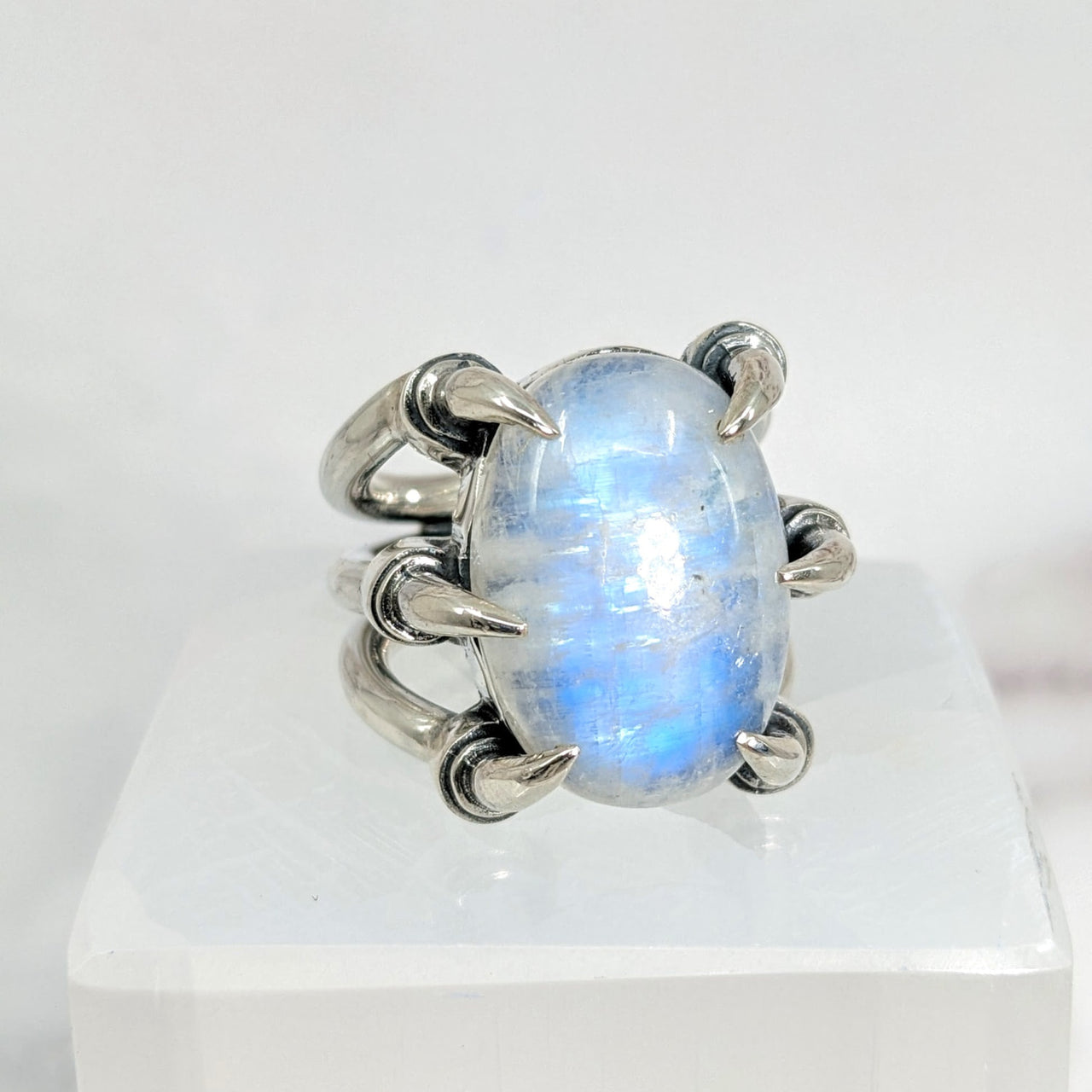 Blue Flash Moonstone Jumbo S.S. Claw Ring Sz. 9.75 on white surface close-up. #LV1726