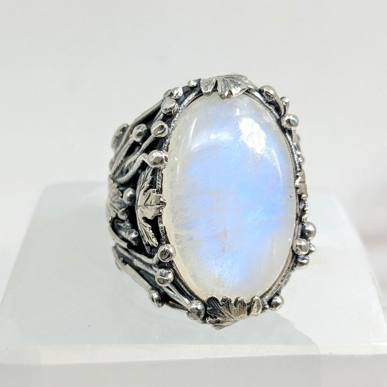 Blue Flash Moonstone Jumbo S.S. Leaf Ring Sz. 10.5 #LV1729 with white stone on white surface