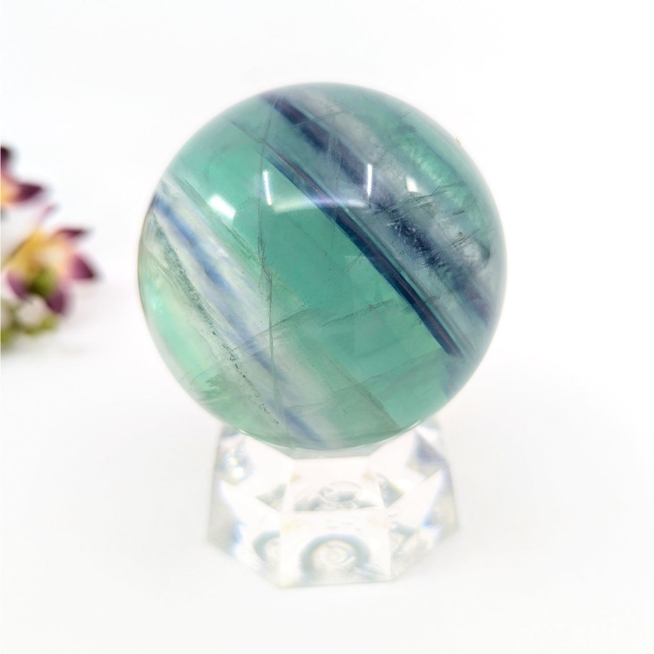 Blue Green Baja Fluorite 2.3-inch striped sphere on clear stand