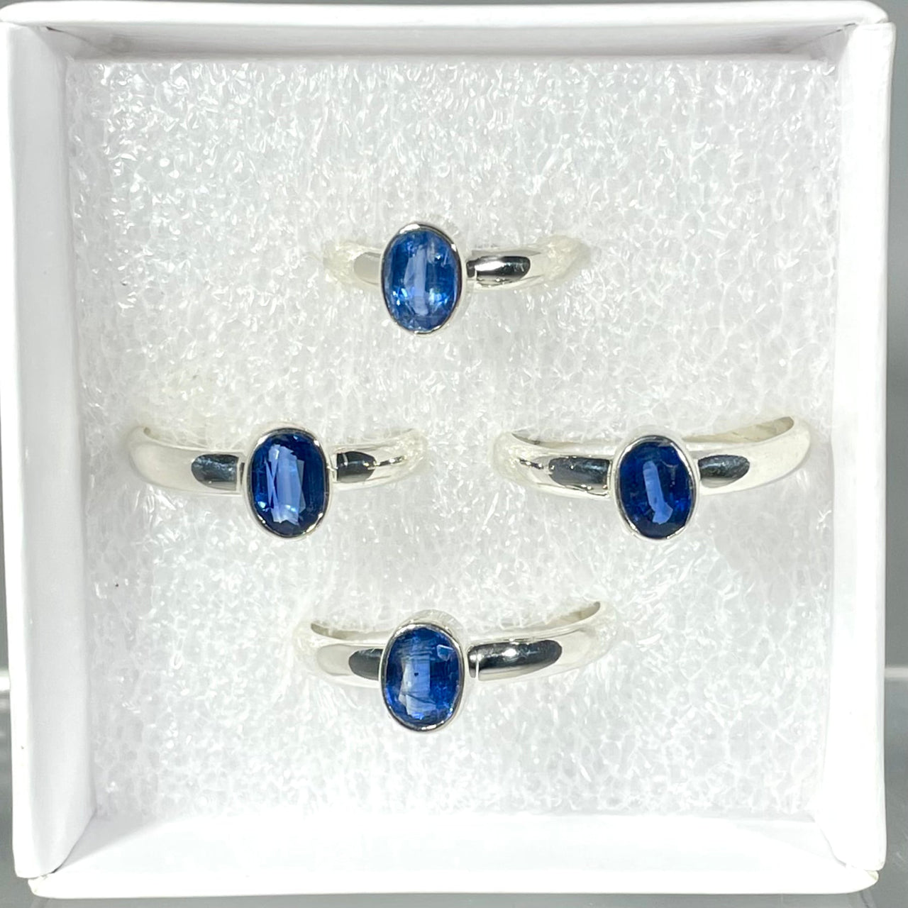 Four silver rings featuring oval blue kyanite stones in a Sterling Silver Ring design