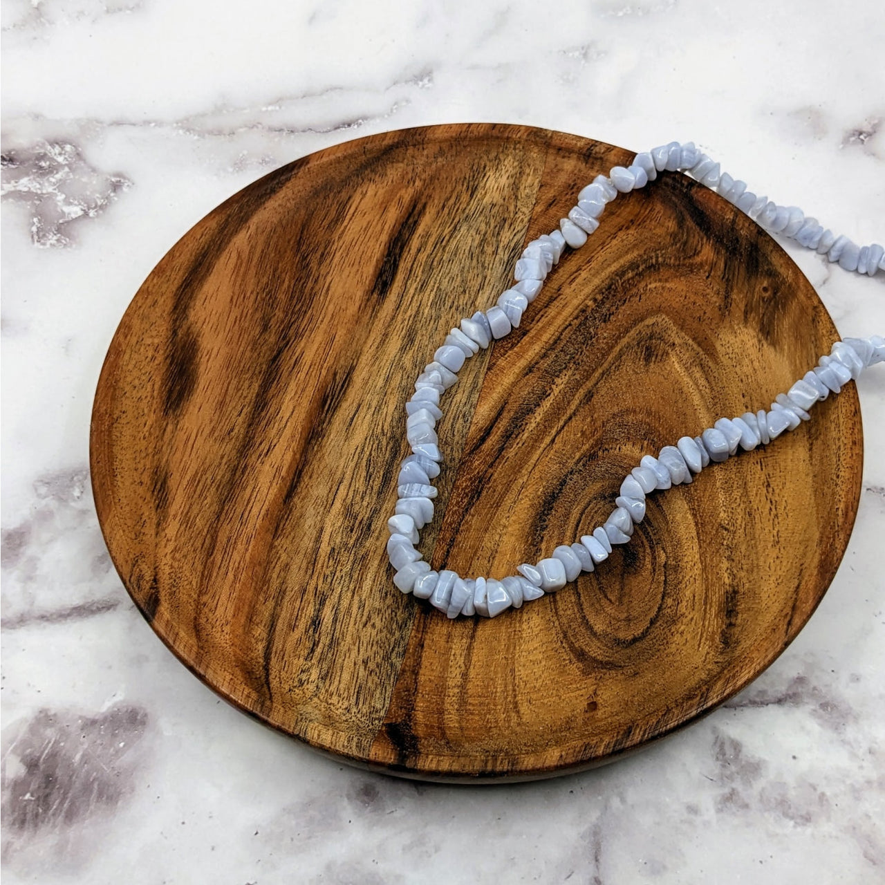 Blue Lace Agate Chip Bead Strand Necklace #LV3658 on a wooden plate