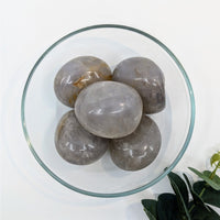 Thumbnail for Polished gray quartz stones in a glass bowl featuring Blue Rose Quartz Pebble N068