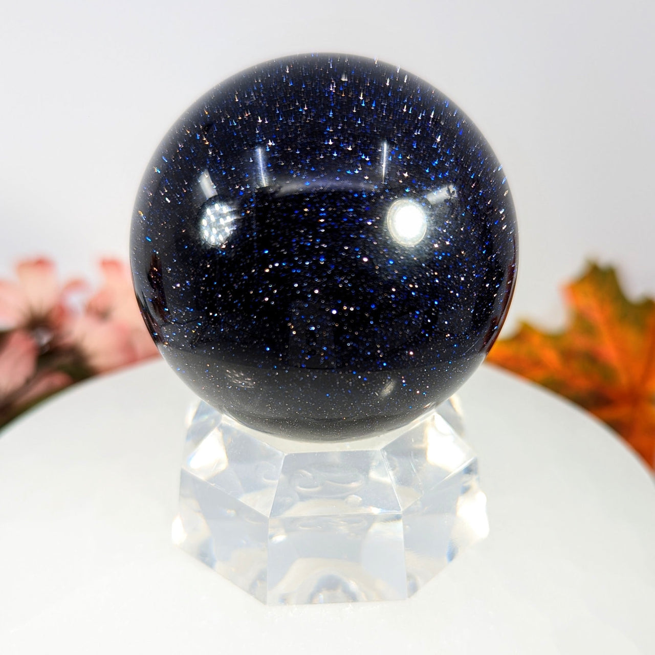 Blue Sandstone 2.3’’ black and white speckled glass sphere on crystal stand #BC0095