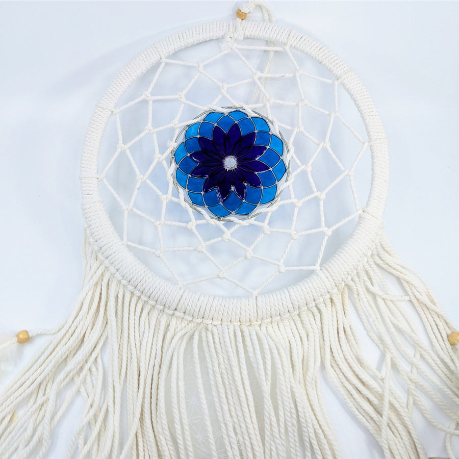 White crochet dreamcatcher with blue stained glass flower design and flowing tassels