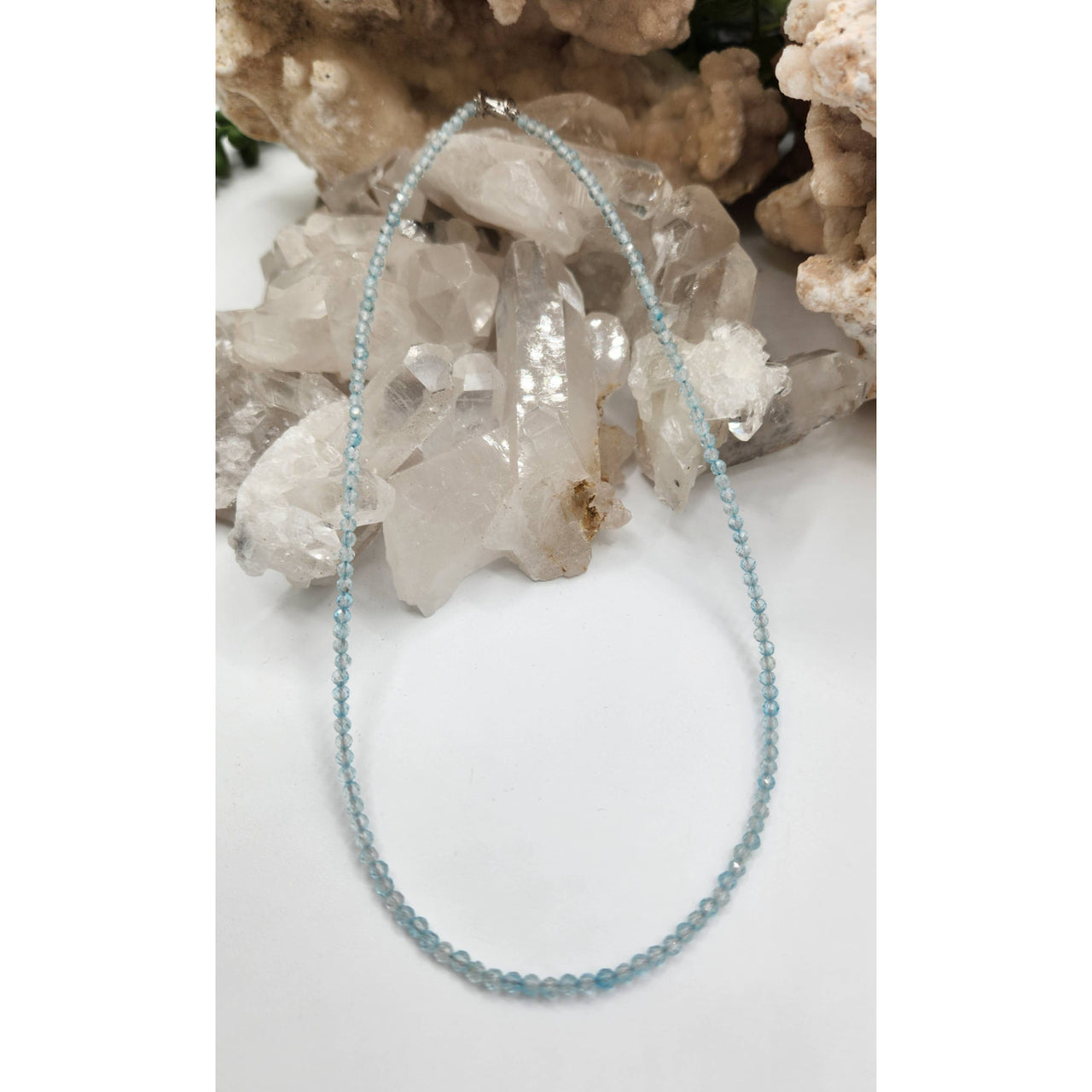 Light blue beaded bracelet with silver accents and topaz design