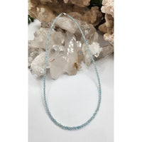 Light blue beaded bracelet with silver accents and topaz design