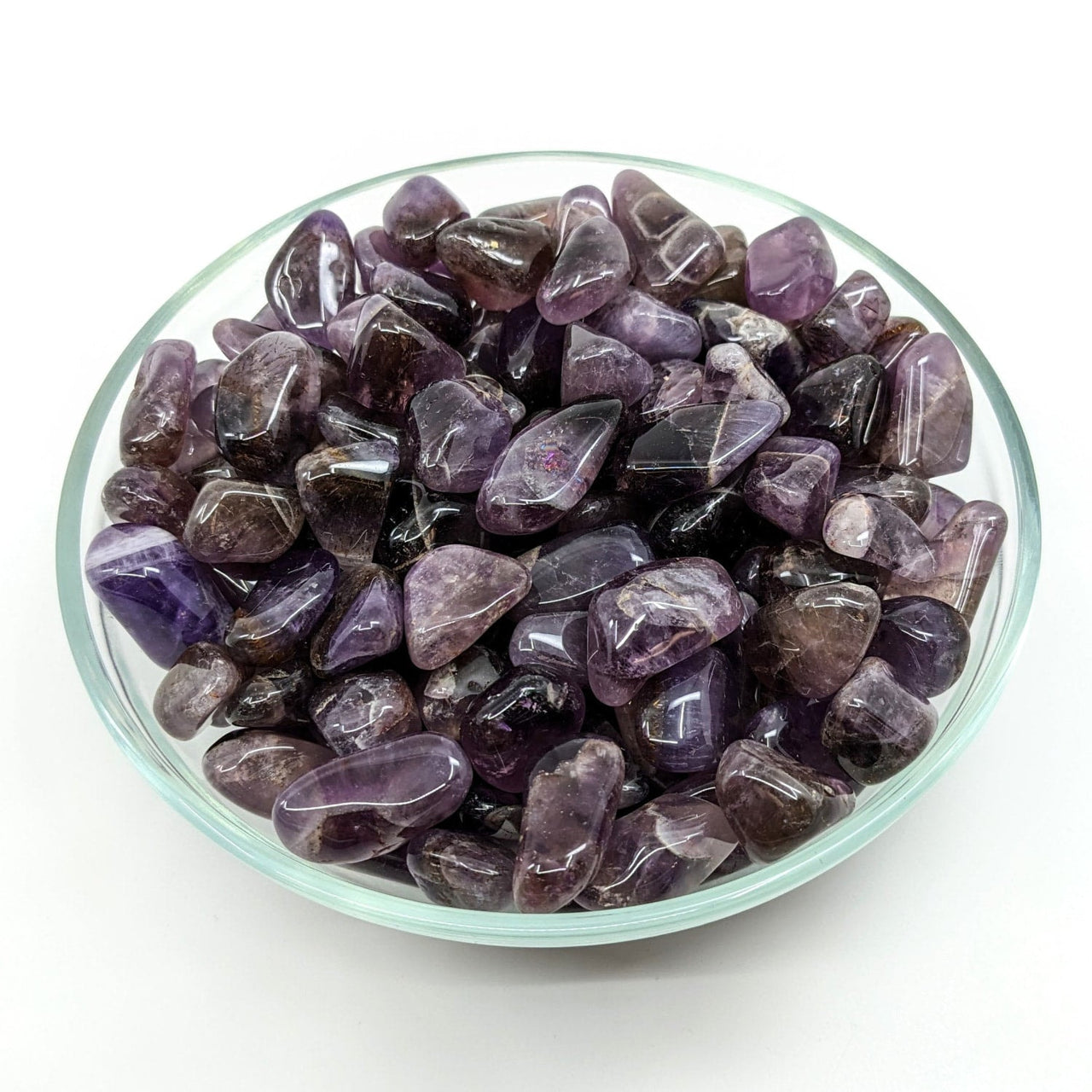 Polished purple Amethyst crystals in a glass dish for BOGO Auralite 23 Tumbled T015