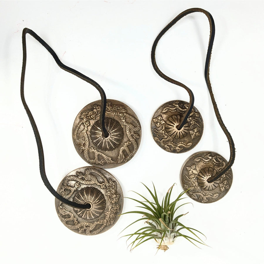 Silver-colored cymbals with leather straps for brass tingsha bell chimes and referral history