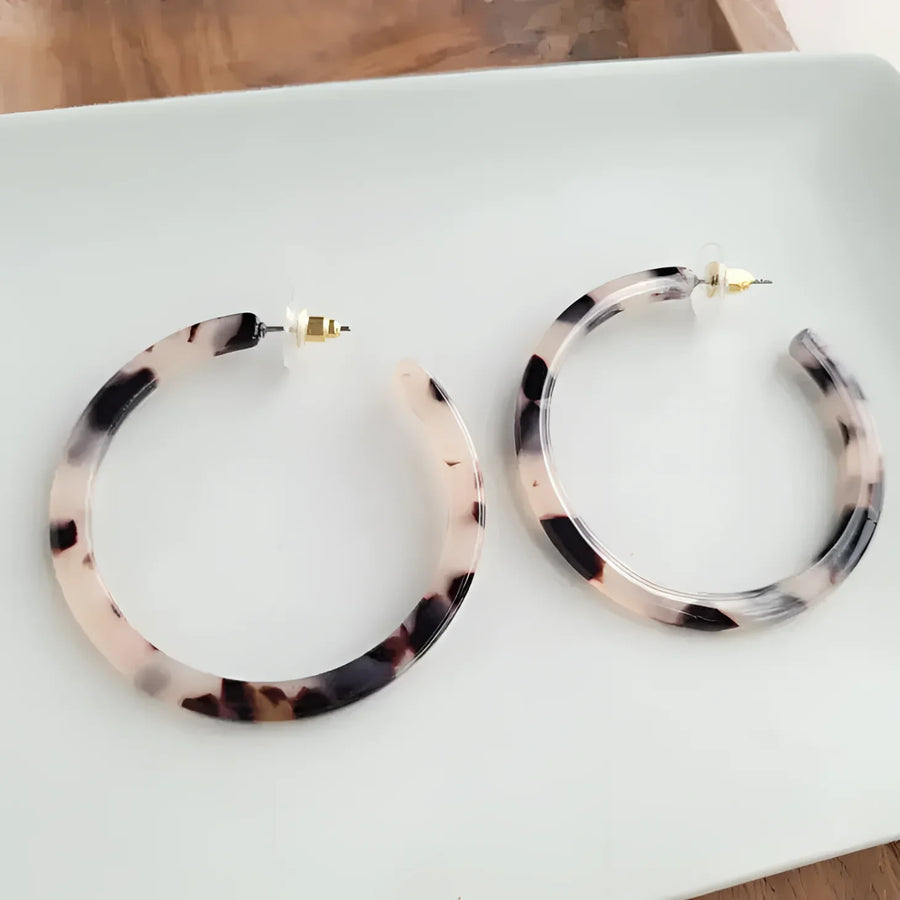 Close-up of Cameron Hoops Tortoise or Blonde earrings on a plate, model #LV3821