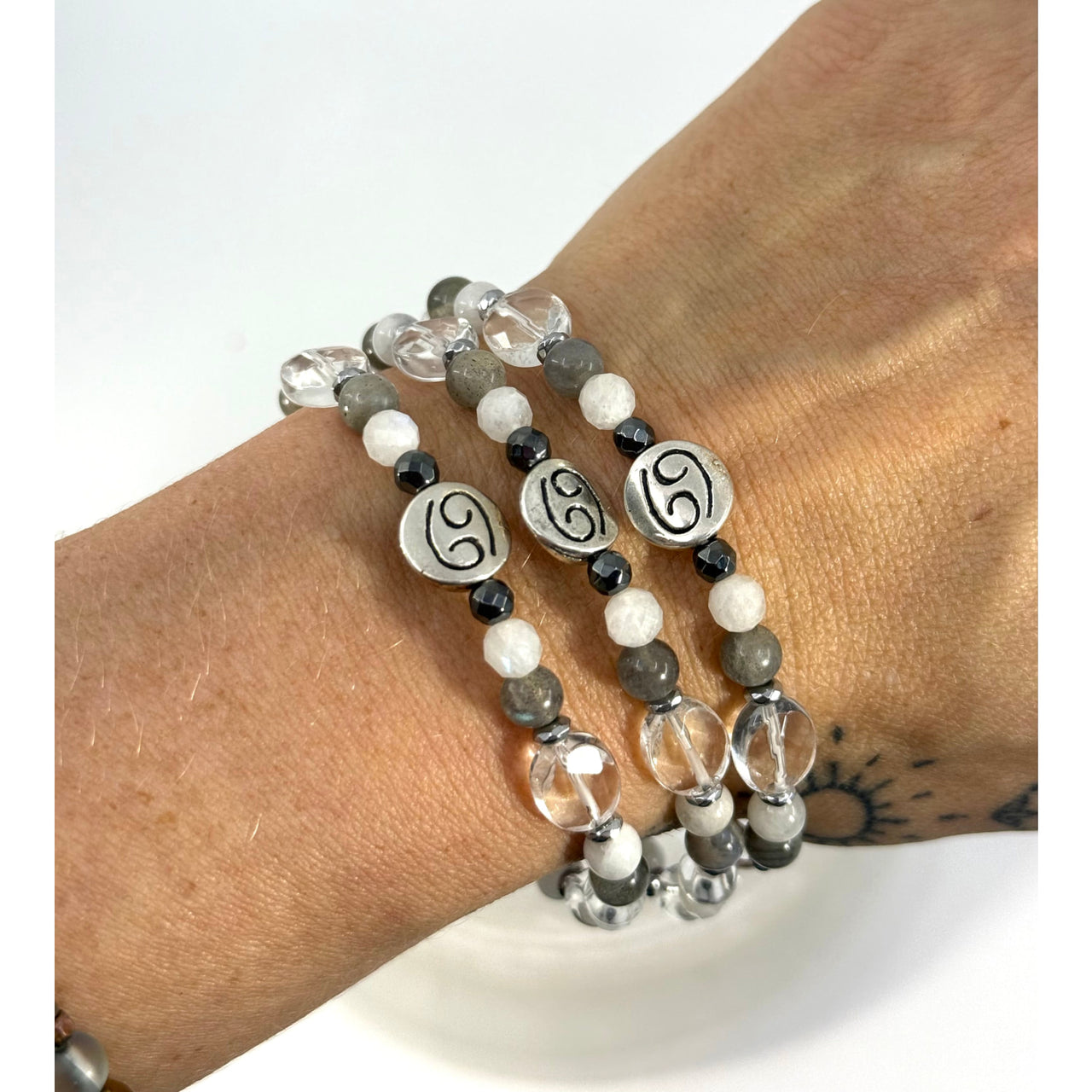 Silver-toned cancer zodiac handmade beaded bracelet with clear white gray beads and black accent stones 7 inches