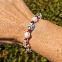 Thumbnail for Woman’s hand wearing Cancer Zodiac Handmade Beaded Bracelet in white and red beads