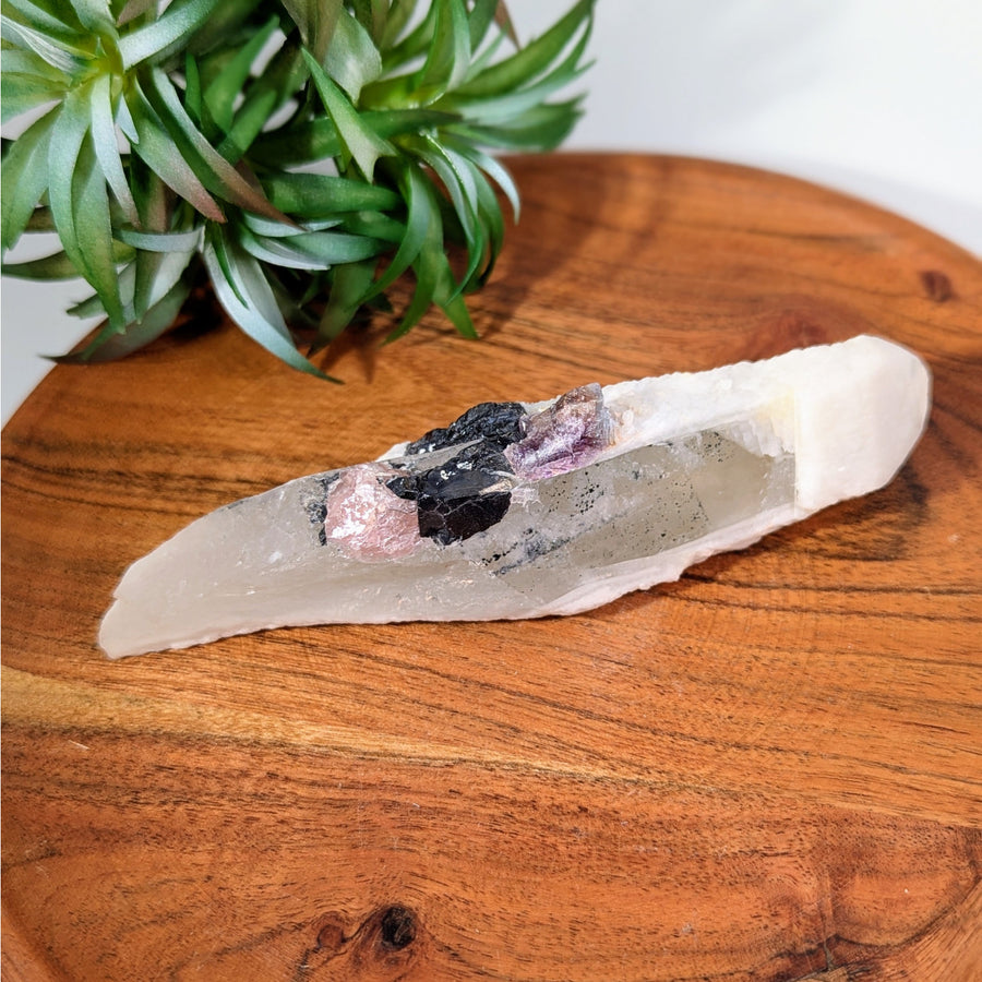 Translucent Candle Quartz with Dark Inclusions and Fluorite Point Displayed in Product