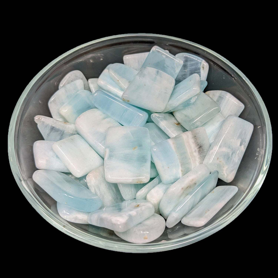 Light blue and white ice cubes in a glass bowl with Caribbean Calcite Slice decor