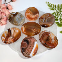 Carnelian 1.5’’ thumb palm stone #BC0760 with oval agate swirls