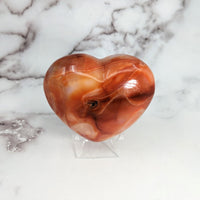 Thumbnail for Carnelian 3.2’ Heart #LV3103: Heart-shaped glass sculpture on marble surface