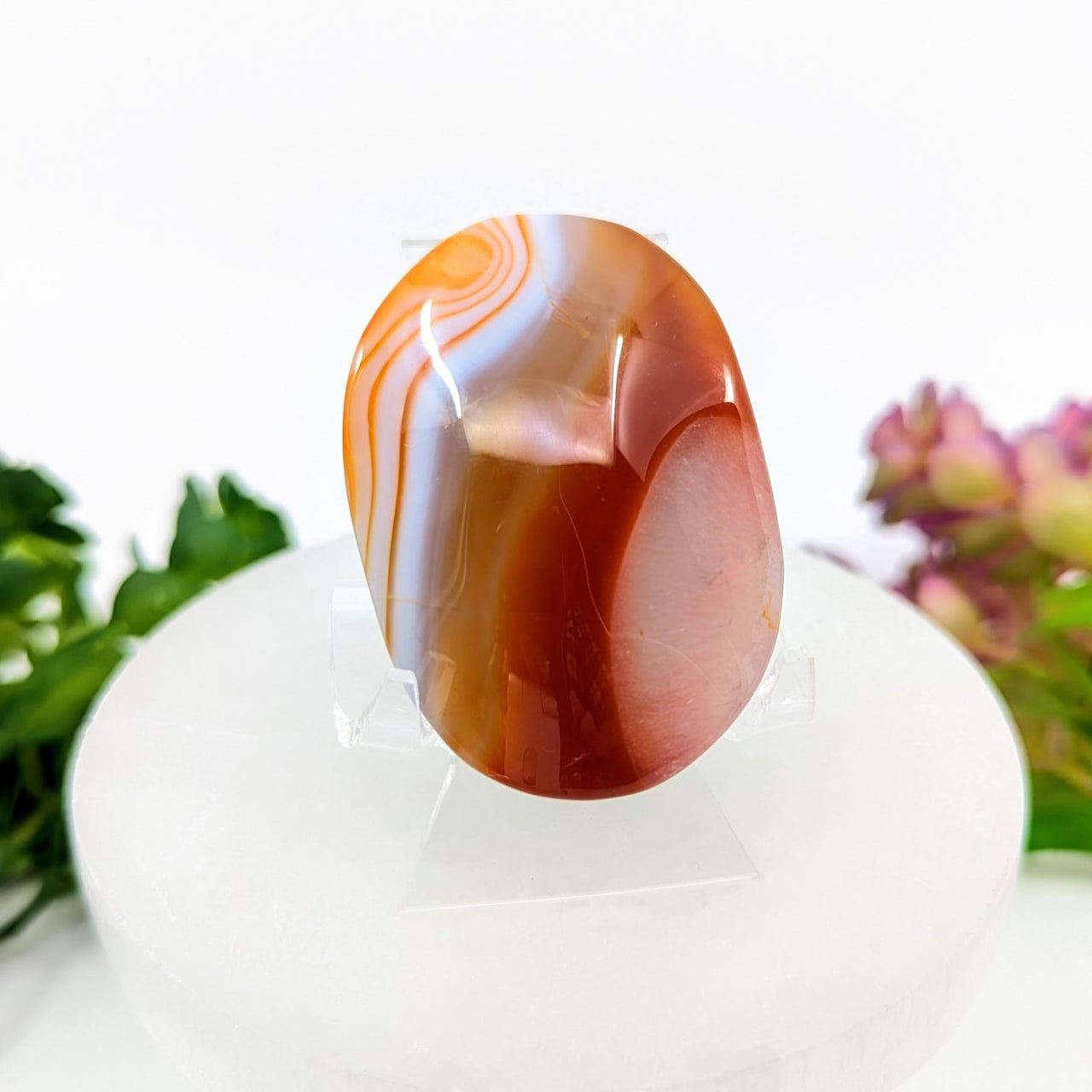 Orange and white carnelian agate 2.1-inch palm stone on display stand #BC0069