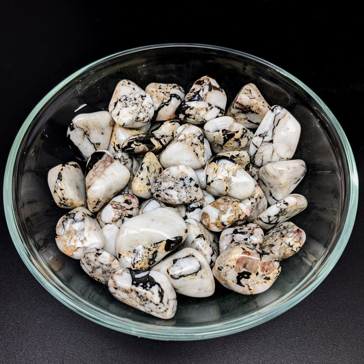 A bowl of tumbled stones from Catacloisite Impact Stone product #LV1273