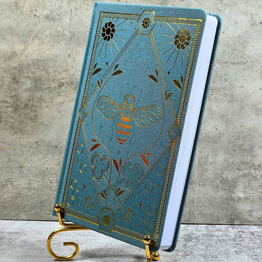 Celestial Nature Gold Foil Journal LV9549 with blue bee notebook on brass stand
