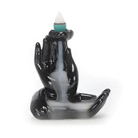 Black ceramic hand-shaped backflow incense burner Q335 with white cone and green base