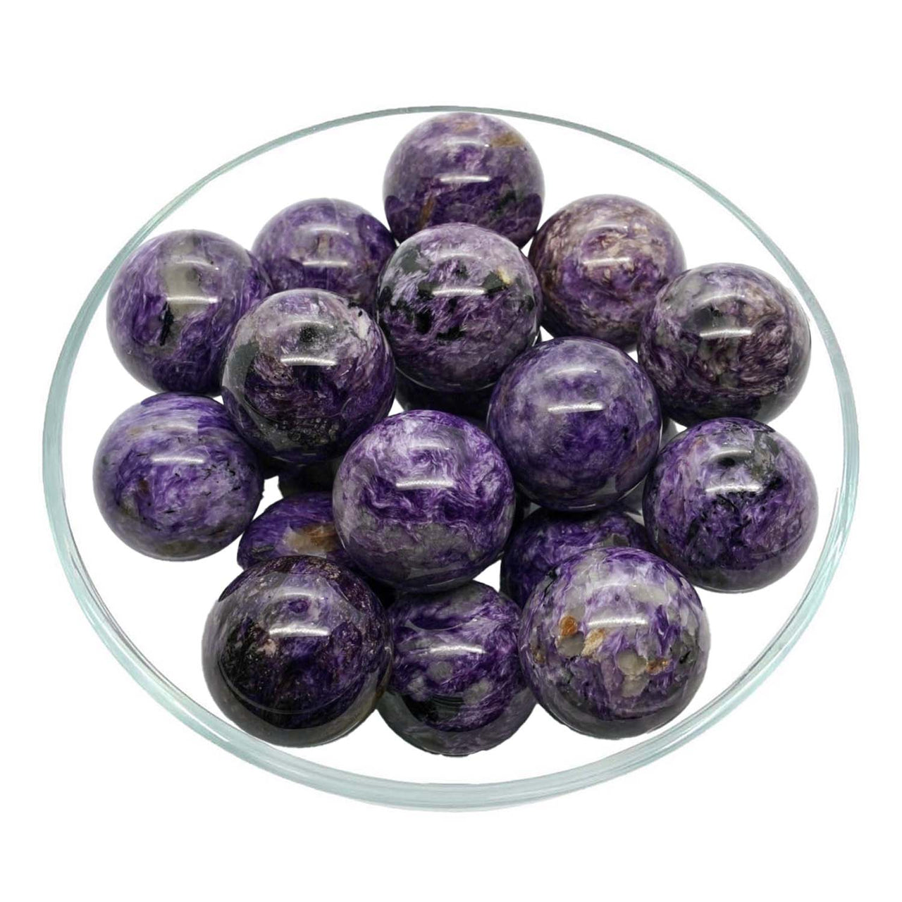 Charoite Sphere displayed on stand with purple marble balls in a stylish bowl