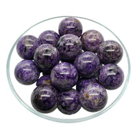 Thumbnail for Charoite Sphere displayed on stand with purple marble balls in a stylish bowl