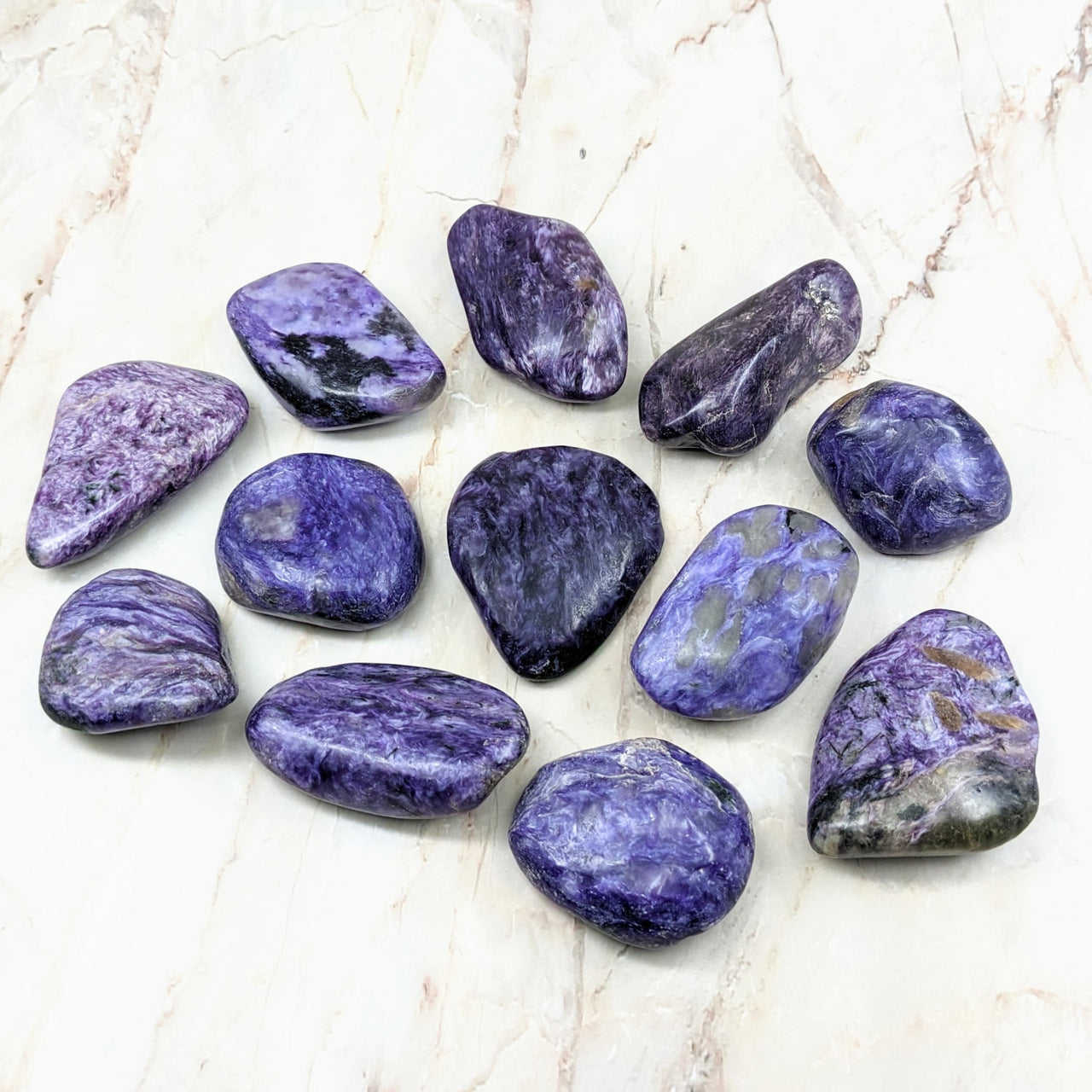 Close up of Charoite Tumbled Stones #SK2183 on marble surface