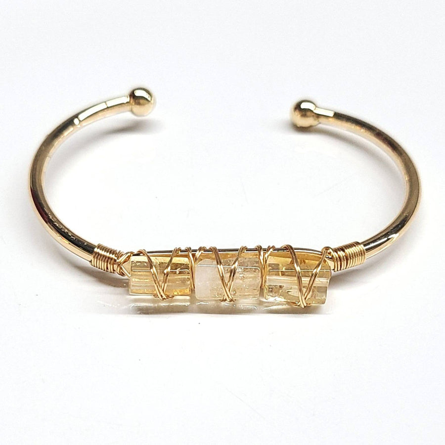 Gold-toned cuff bangle bracelet with three wrapped citrine stones for stylish 5-inch wristwear model BC0491