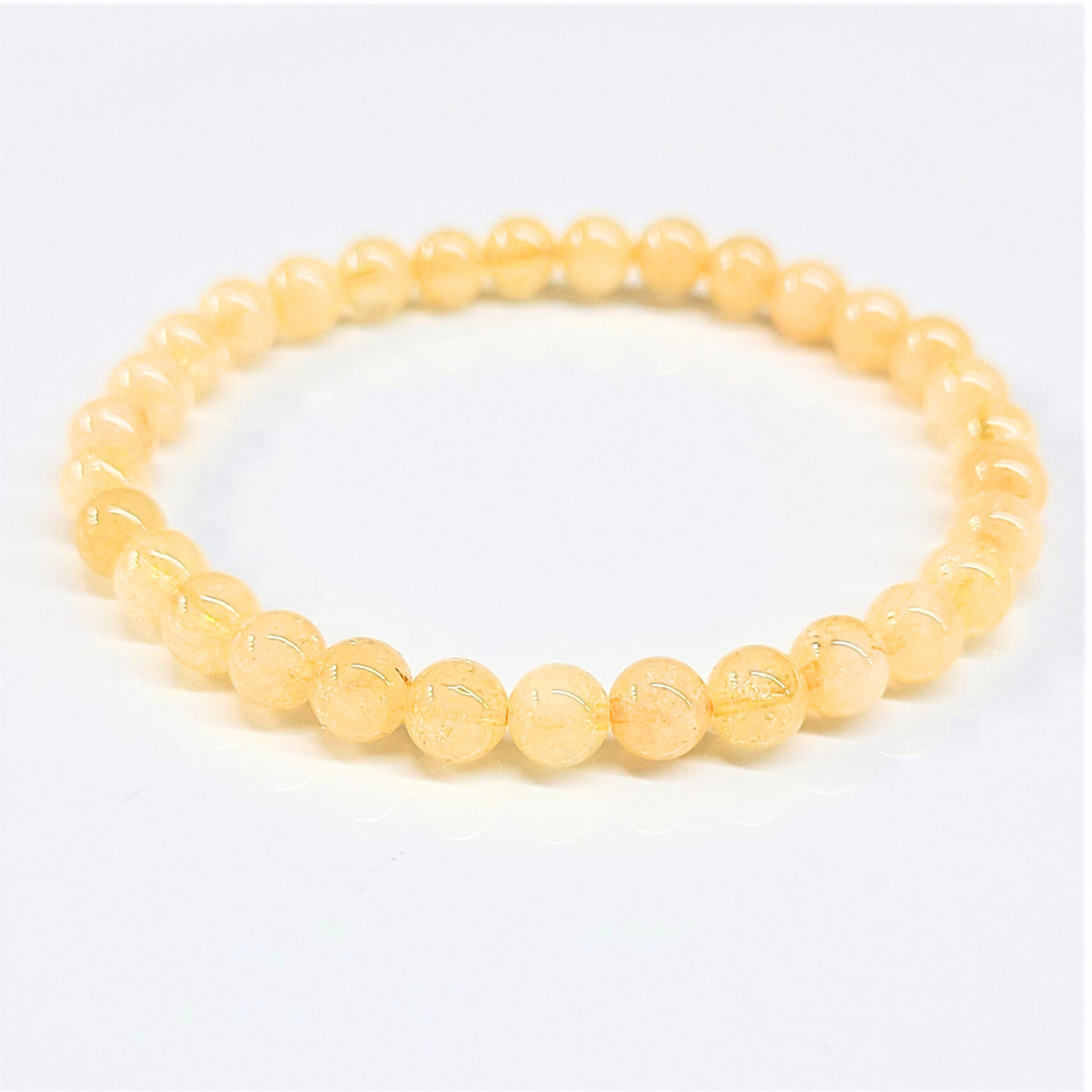 Citrine 8 inch 6mm beaded bracelet featuring delicate translucent yellow amber beads with smooth rounded design