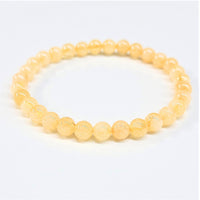 Citrine 8 inch 6mm beaded bracelet featuring delicate translucent yellow amber beads with smooth rounded design