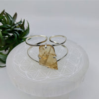 Silver cuff bracelet with amber pendant showcasing citrine gem cuff that attracts prosperity