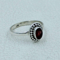 Oval faceted garnet sterling silver ring with beaded border, BC0407