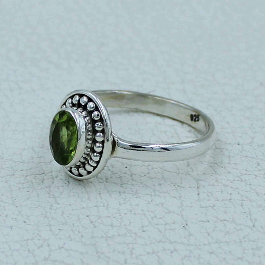 Oval faceted citrine or peridot sterling silver ring with beaded bezel