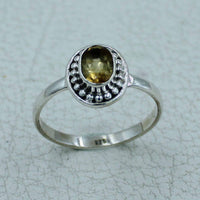 Oval citrine or peridot faceted sterling silver ring with bezel accents