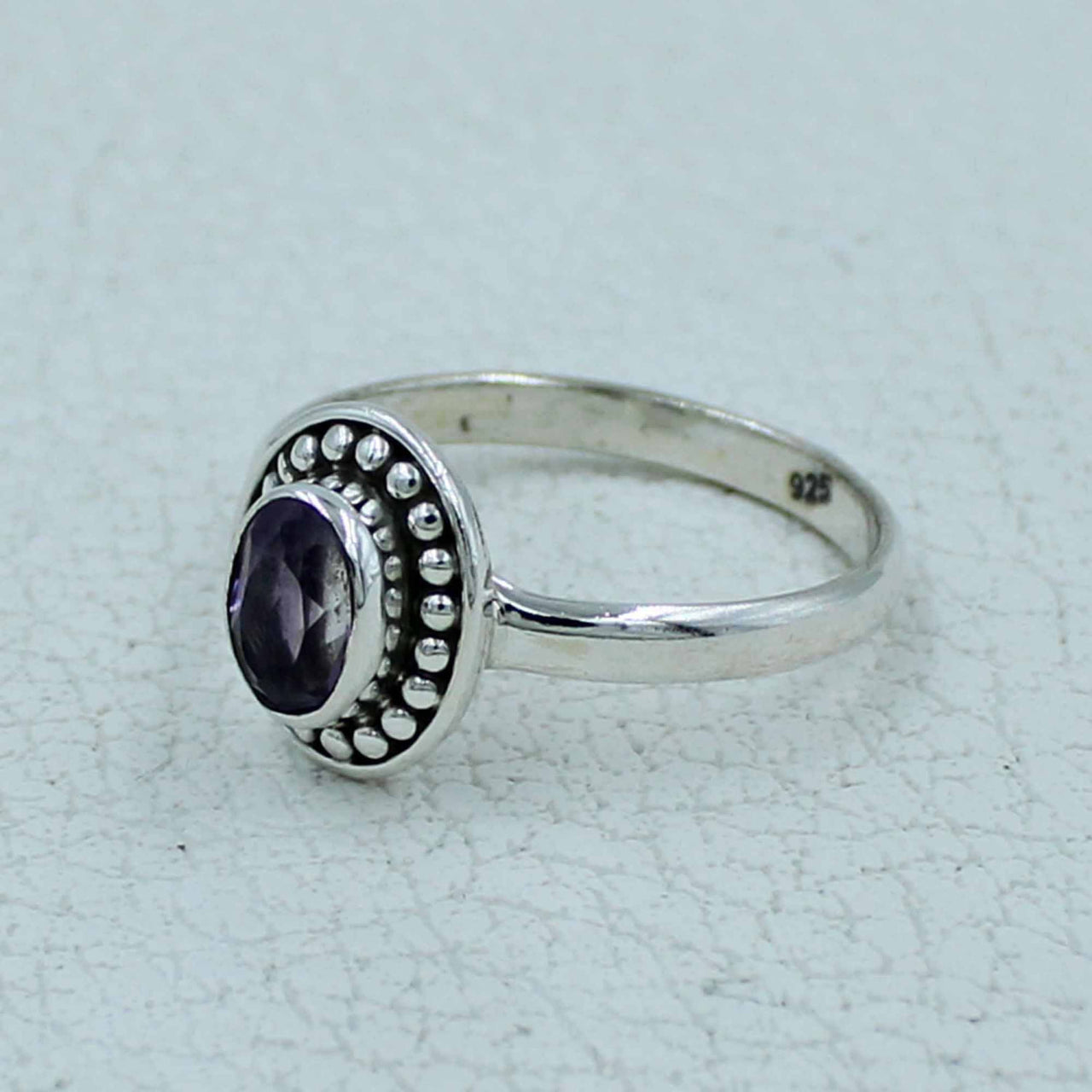 Oval faceted amethyst sterling silver ring with ornate beaded bezel