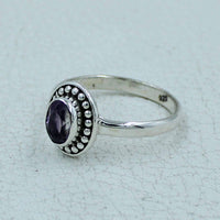 Oval faceted amethyst sterling silver ring with ornate beaded bezel