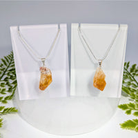 Two citrine point rough pendant necklaces with raw orange-yellow crystals on delicate silver chains for jewelry
